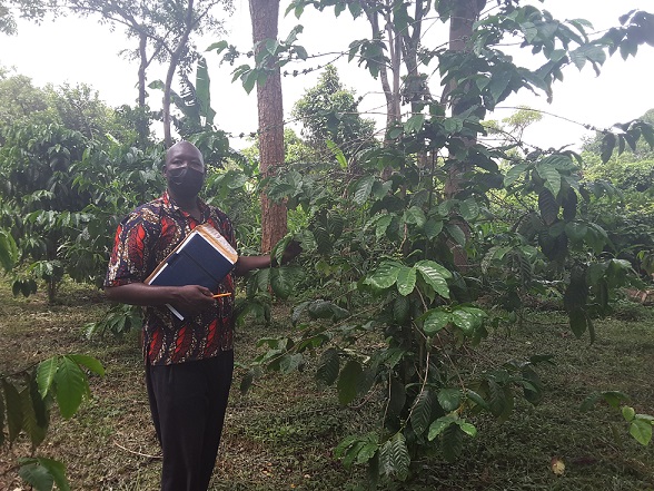 muru DPO inspecting coffee plantation of one of the farmers in Guruguru Sub County