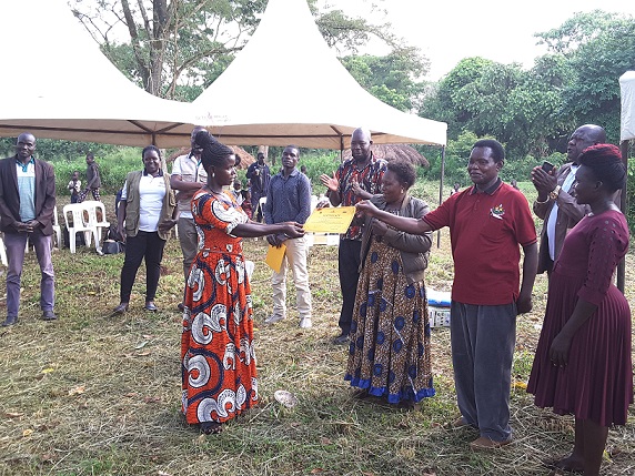 Doreen receiving gift from Amuru district officials